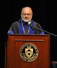 man by podium with microphone