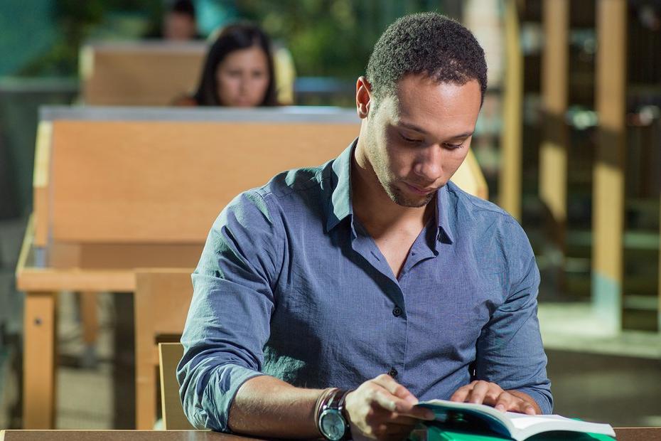 Student reading in library